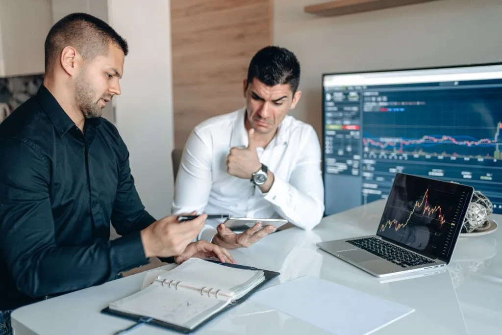Professionnels analysant des données sur des appareils numériques au bureau